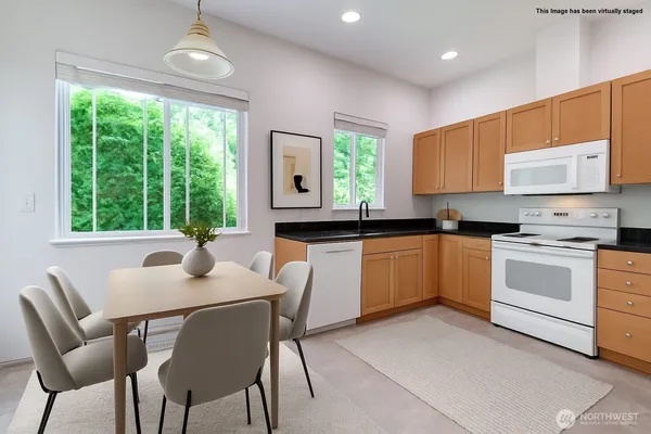 a kitchen with a stove a sink a table and chairs