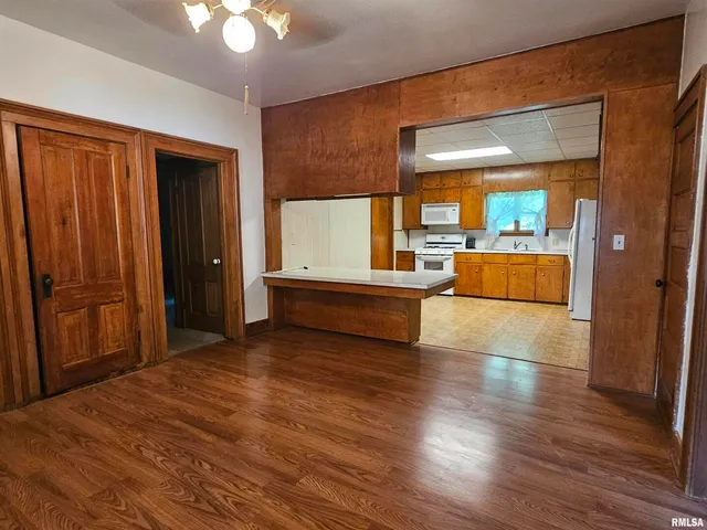 a view of a room with wooden floor and furniture