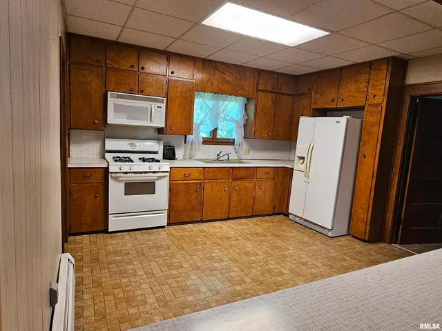 a kitchen with a refrigerator sink and stove