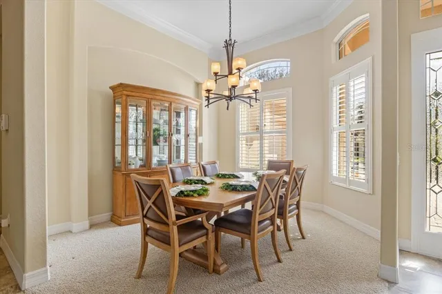 a dining room with furniture and a large window