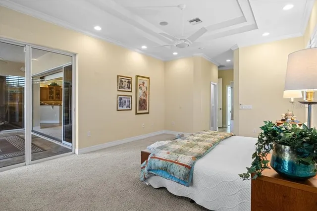 a view of a white building with swimming pool in front of it