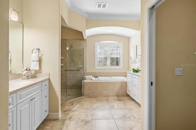 a view of a white building with swimming pool in front of it