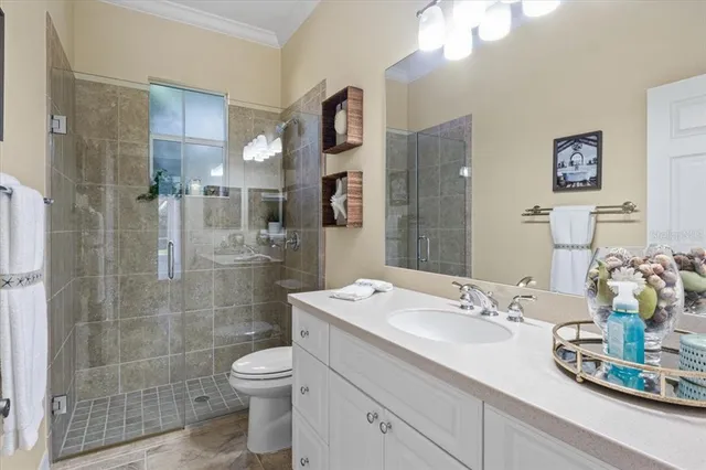 an aerial view of ocean and residential houses with outdoor space