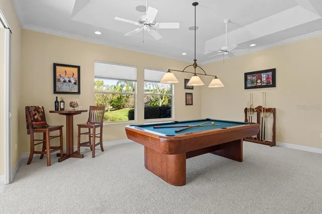 a view of a swimming pool with a yard and large trees