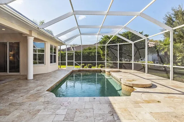 a view of a house with swimming pool and sitting area