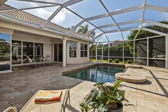 a view of a house with swimming pool and sitting area