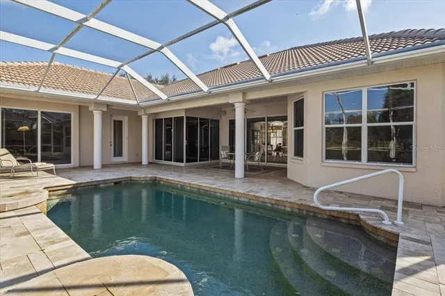 an aerial view of a golf course with a lake view