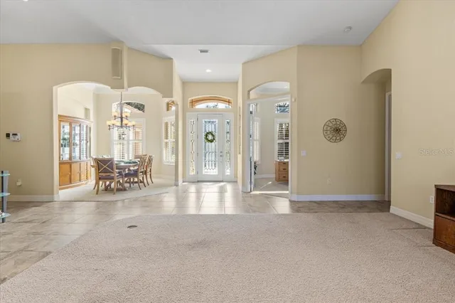a dining room with furniture a chandelier and a rug