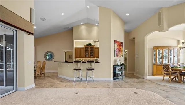 a dining room with furniture a rug and a chandelier