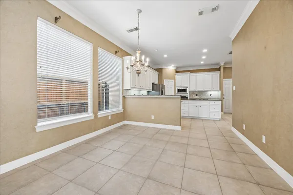 a living room with furniture kitchen and a large window