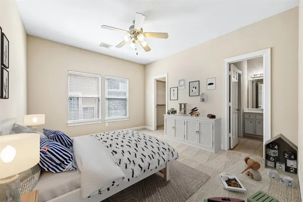 an empty room with chandelier fan and windows