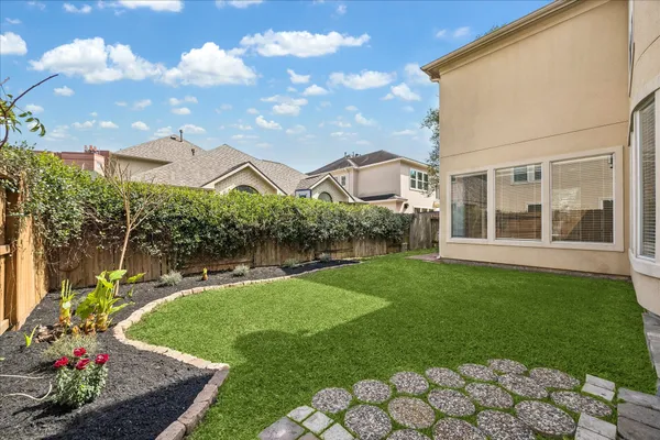 a kitchen with stainless steel appliances granite countertop a sink and a stove