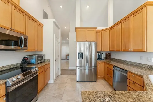 a kitchen with stainless steel appliances granite countertop a sink and cabinets