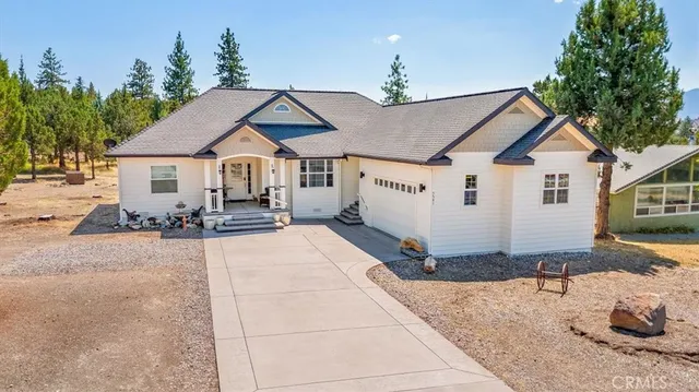 a view of a house with couches and wooden floor