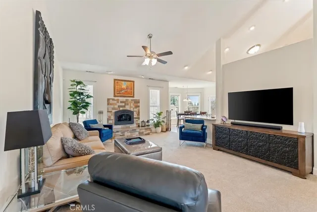 a living room with furniture fireplace and a window