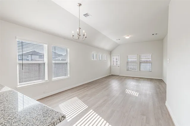 a view of a room with wooden floor and windows