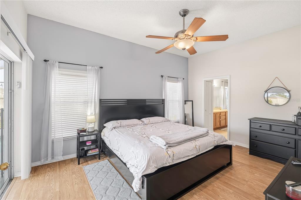 13107 Heming Way Orlando, FL 32825 - Photo 12 of 23 a bedroom with a bed and wooden floor