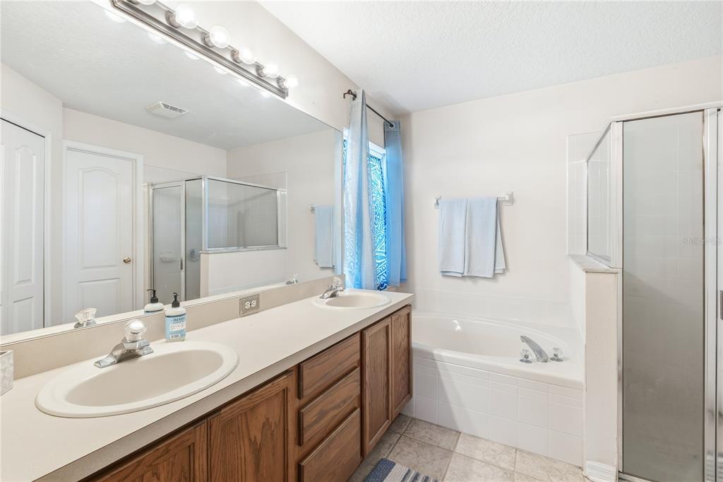 13107 Heming Way Orlando, FL 32825 - Photo 14 of 23 a bathroom with a double vanity sink mirror double and bathtub