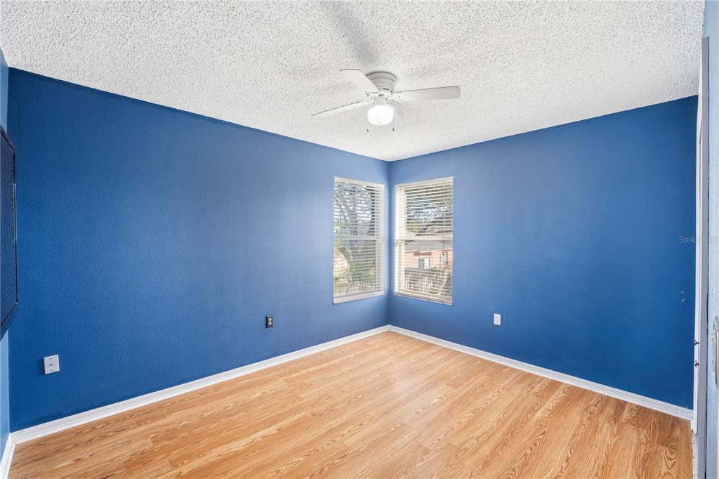 13107 Heming Way Orlando, FL 32825 - Photo 16 of 23 a view of a big room with windows and chandelier fan