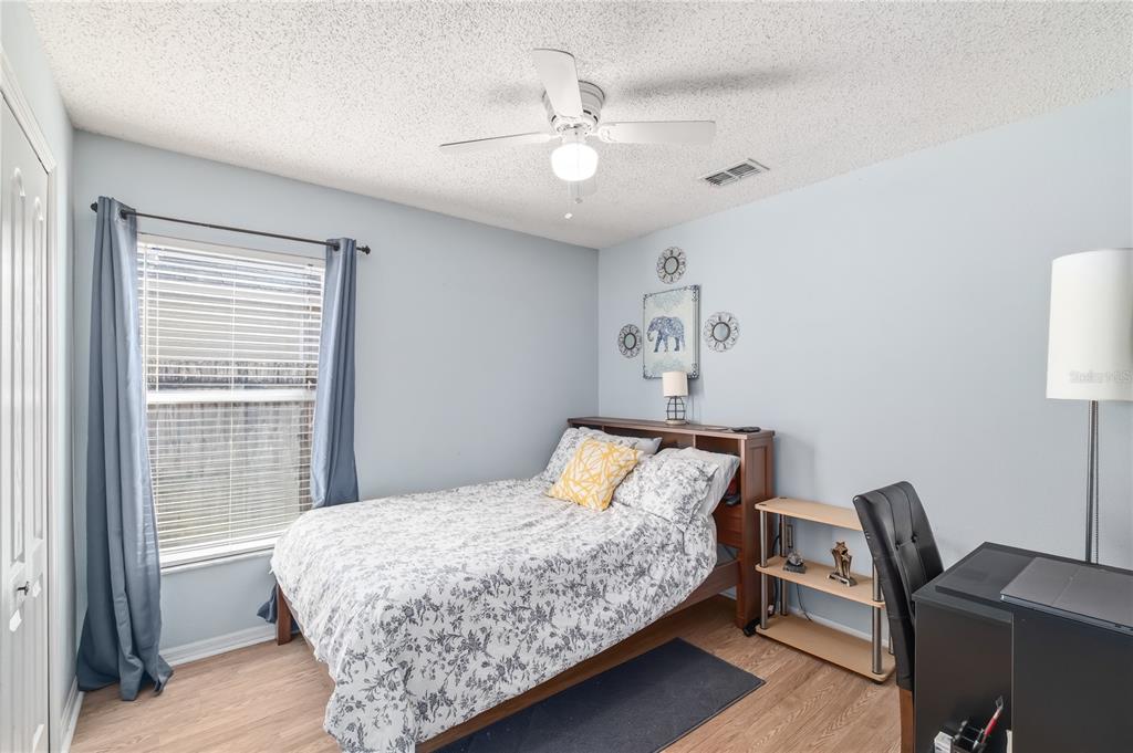 13107 Heming Way Orlando, FL 32825 - Photo 18 of 23 a bedroom with a bed a desk and chair