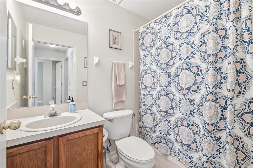 13107 Heming Way Orlando, FL 32825 - Photo 19 of 23 a bathroom with a granite countertop toilet sink and mirror
