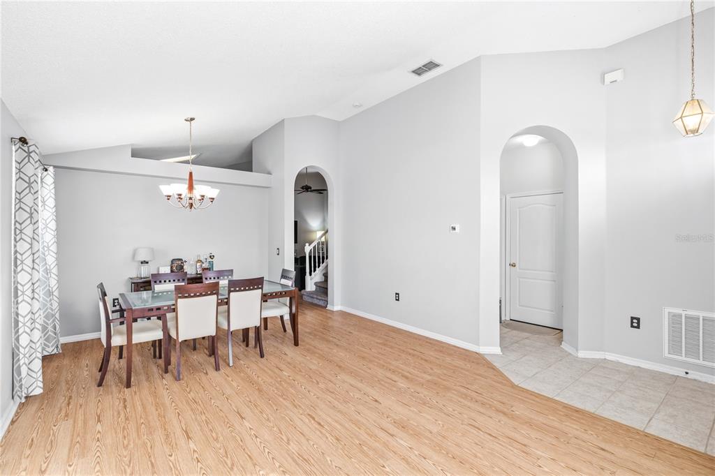 13107 Heming Way Orlando, FL 32825 - Photo 3 of 23 a dining room with furniture a chandelier and wooden floor