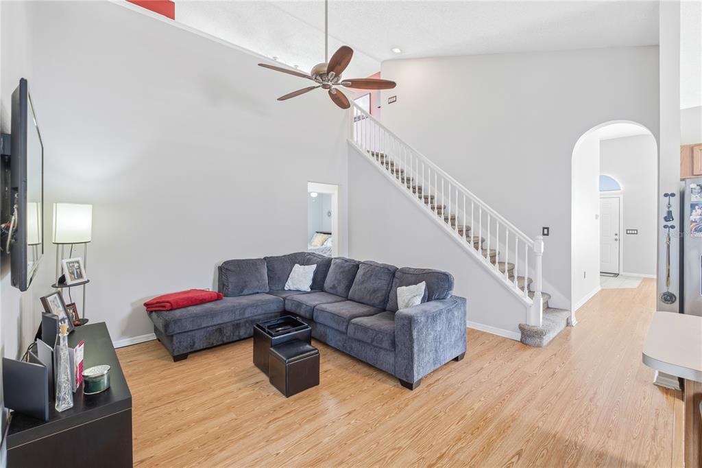 13107 Heming Way Orlando, FL 32825 - Photo 5 of 23 a living room with furniture or stairs and a wooden floor