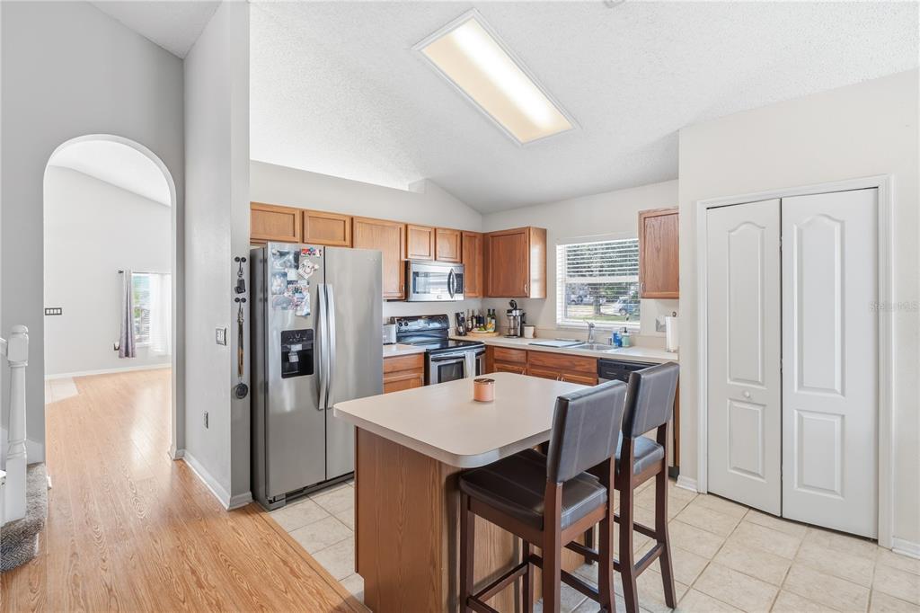 13107 Heming Way Orlando, FL 32825 - Photo 8 of 23 a kitchen with stainless steel appliances a refrigerator and wooden floor