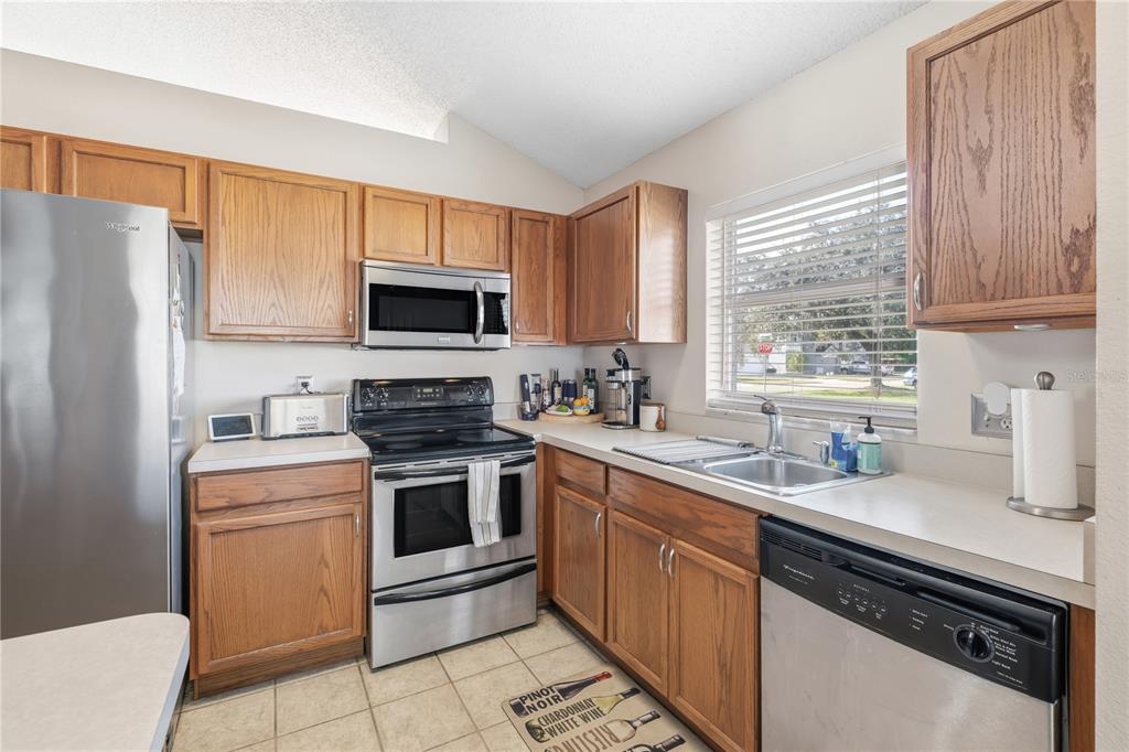 13107 Heming Way Orlando, FL 32825 - Photo 9 of 23 a kitchen with a sink stove and microwave