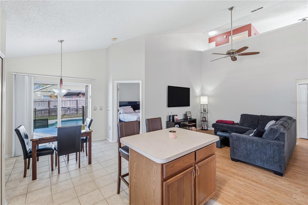13107 Heming Way Orlando, FL 32825 - Photo 10 of 23 a living room with furniture a chandelier and a flat screen tv