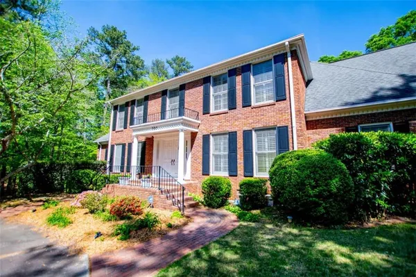 a front view of a house with swimming pool and porch