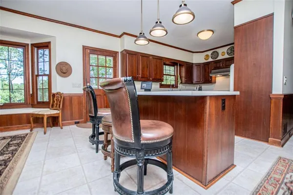 a kitchen with stainless steel appliances granite countertop a sink a microwave and cabinets