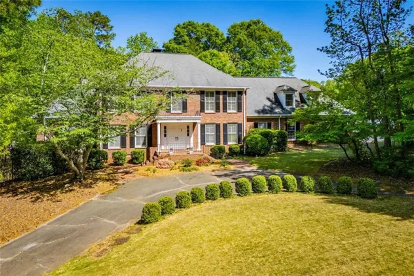 a front view of a house with swimming pool and porch