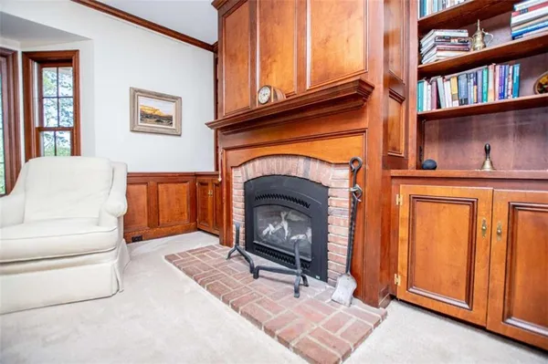 a living room with furniture and a book shelf