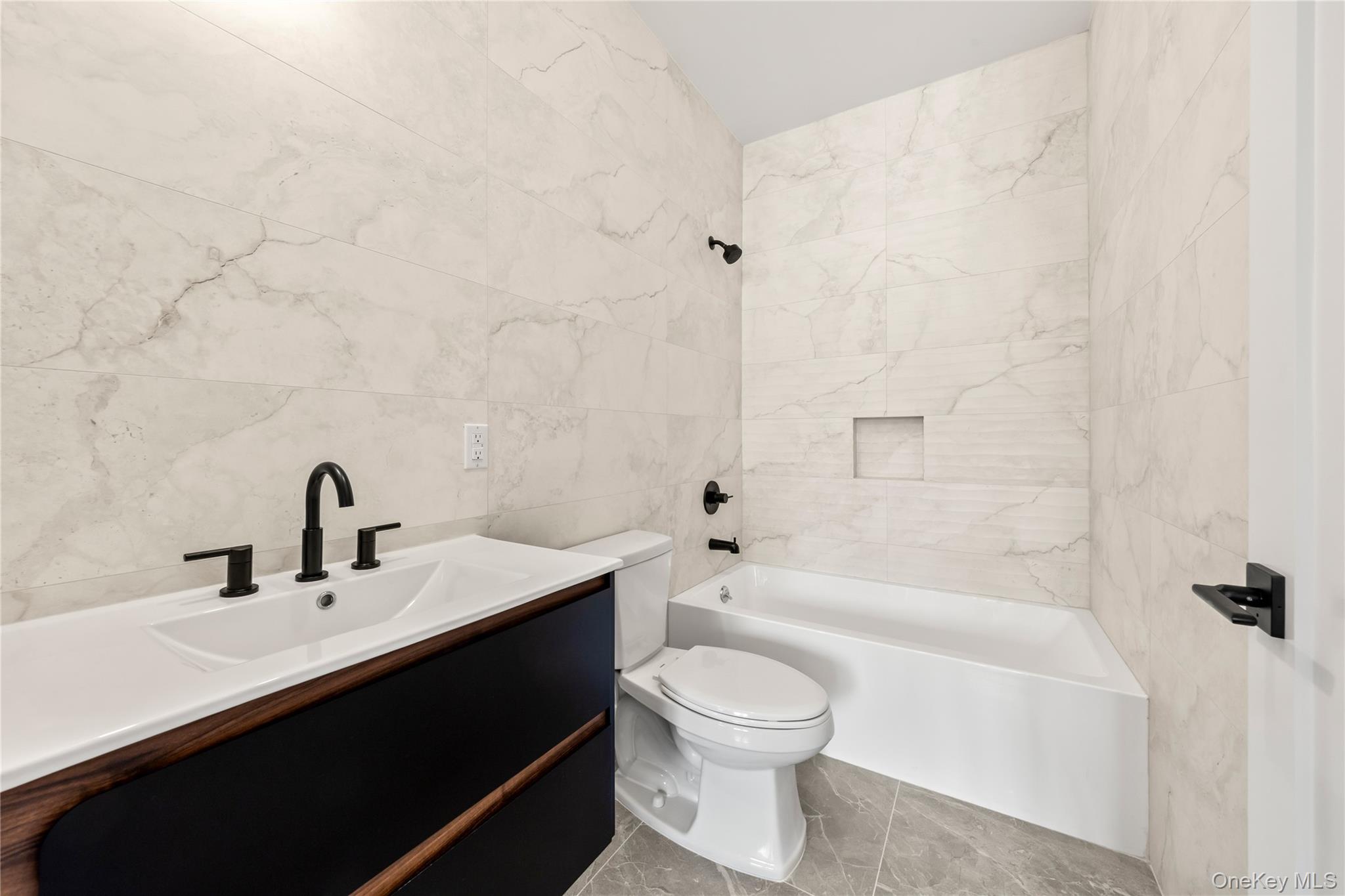 5 Jeffrey Place, Unit 102 Monsey, NY 10952 - Photo 14 of 23 a bathroom with a sink a toilet and bathtub