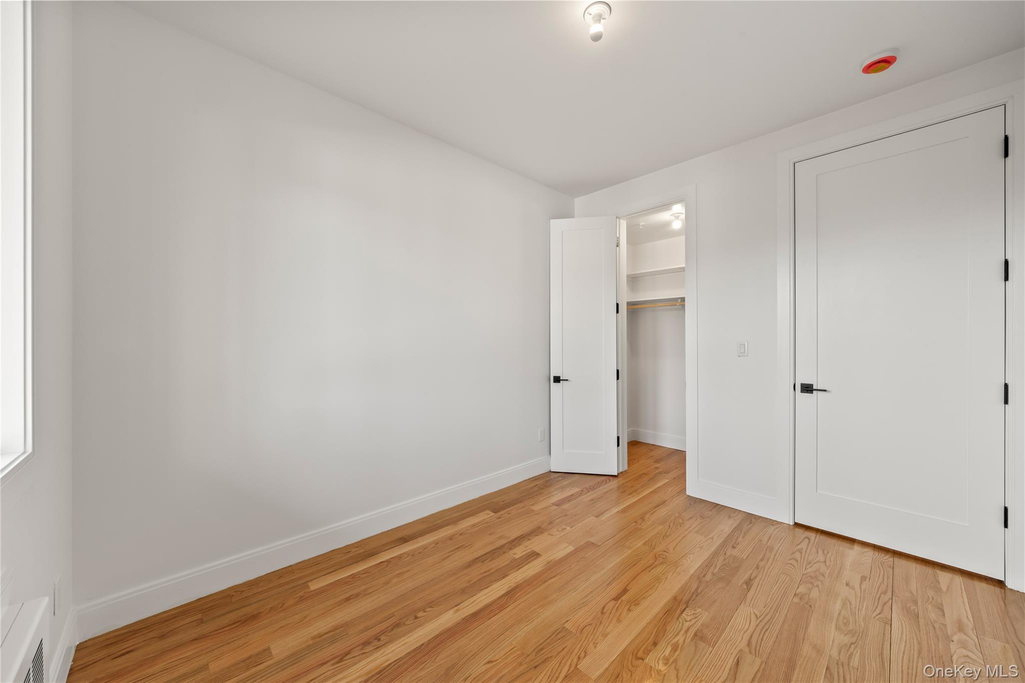 5 Jeffrey Place, Unit 102 Monsey, NY 10952 - Photo 17 of 23 a view of a room with wooden floor and white walls