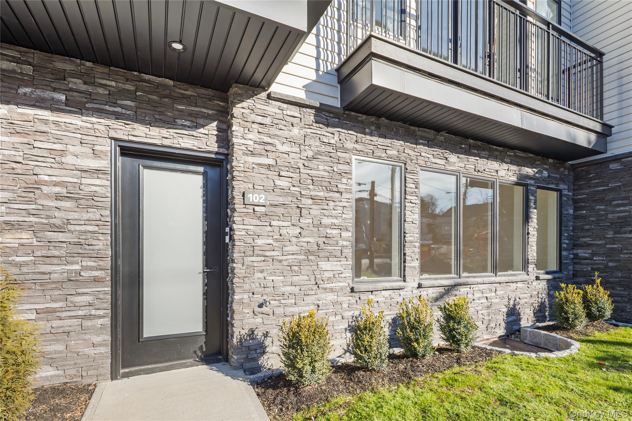 5 Jeffrey Place, Unit 102 Monsey, NY 10952 - Photo 2 of 23 a front view of a house with a yard