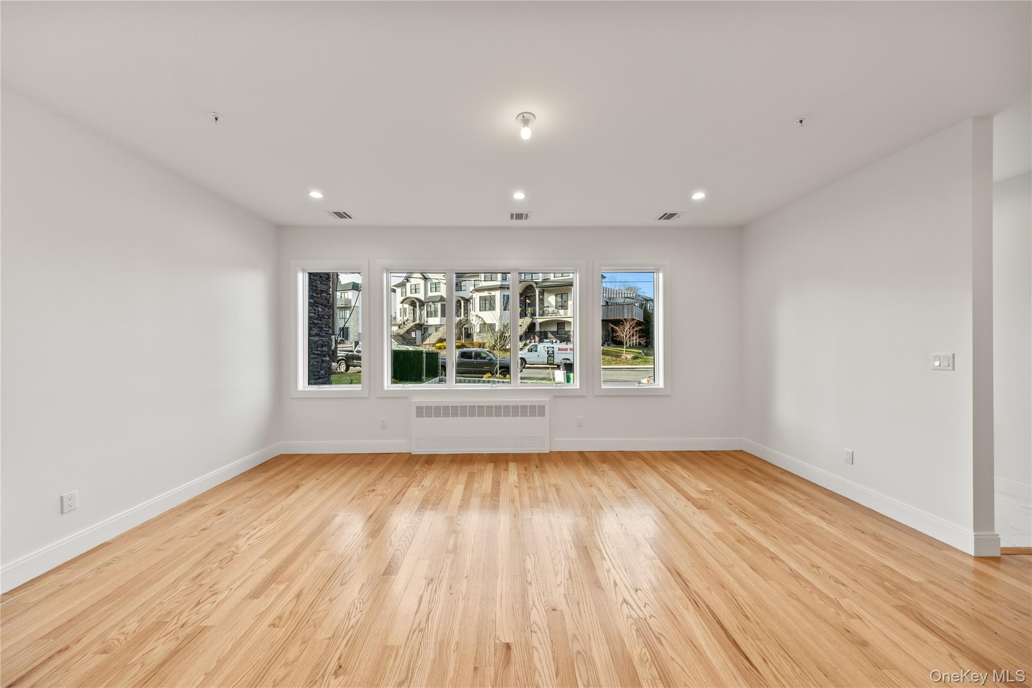 5 Jeffrey Place, Unit 102 Monsey, NY 10952 - Photo 4 of 23 wooden floor in an empty room with a window