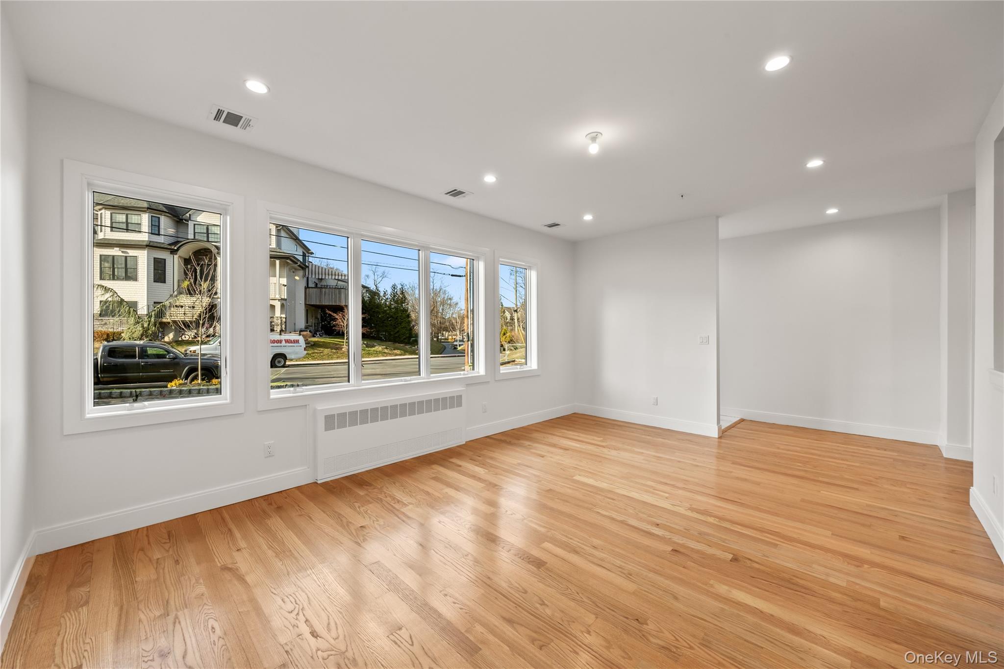 5 Jeffrey Place, Unit 102 Monsey, NY 10952 - Photo 5 of 23 a view of an empty room with a window and wooden floor