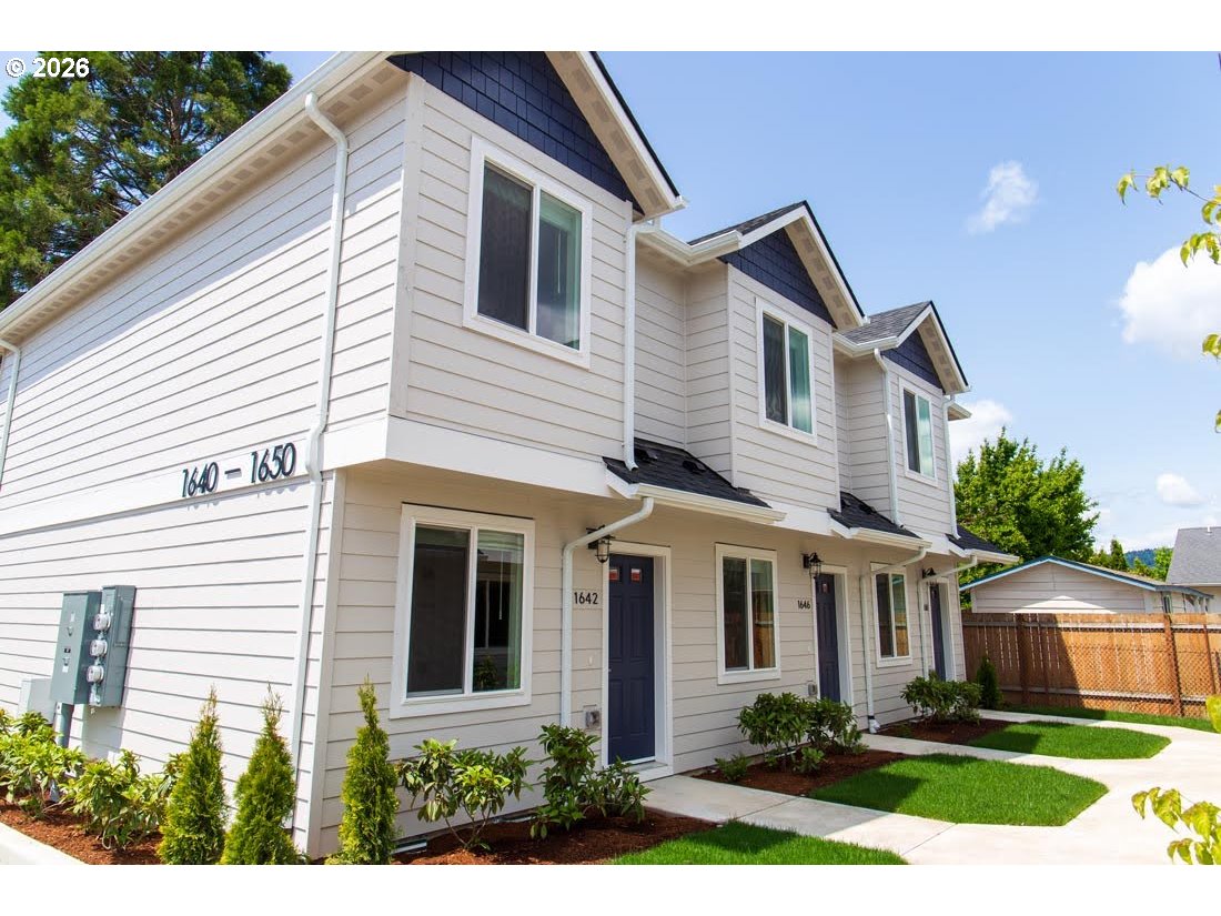 a front view of a house with garden