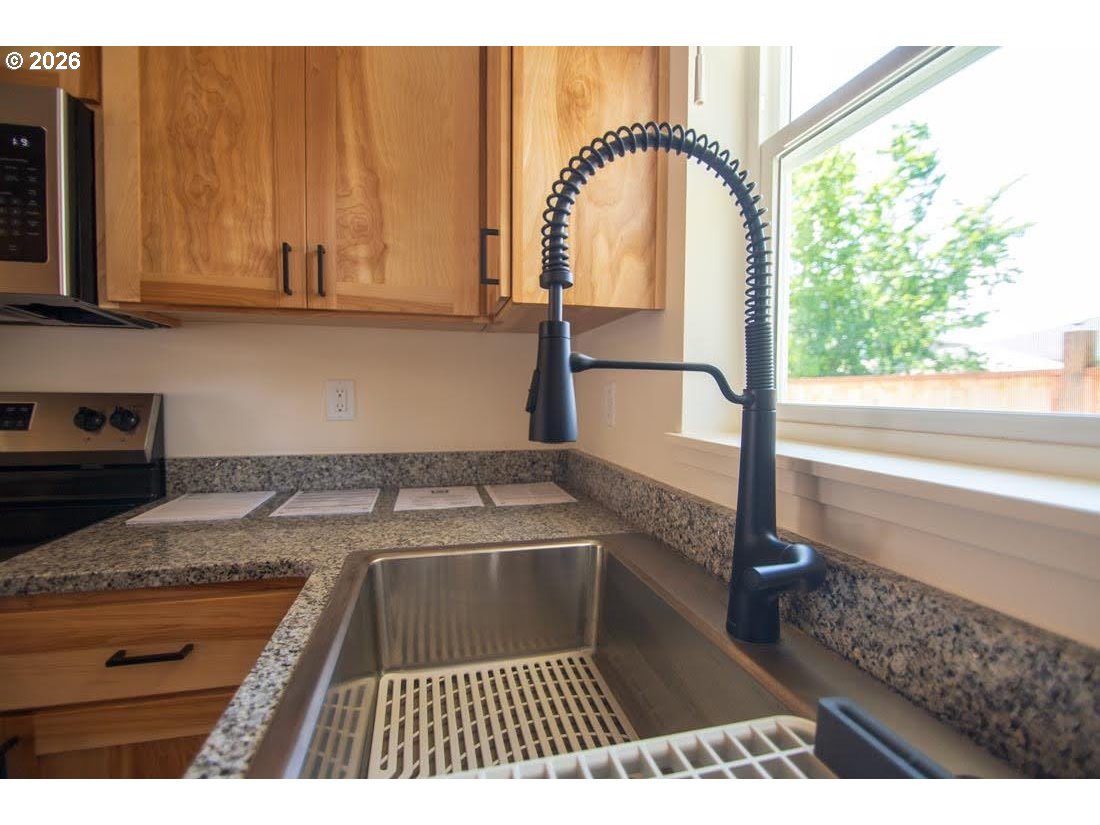 1638 S Street Springfield, OR 97477 - Photo 12 of 31 a view of a kitchen with a sink and wooden floor