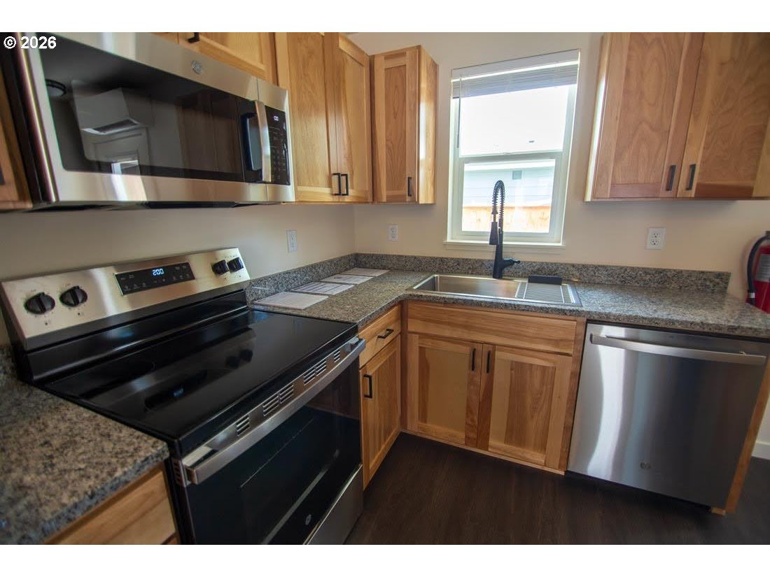 1638 S Street Springfield, OR 97477 - Photo 13 of 31 a kitchen with a sink stove and microwave
