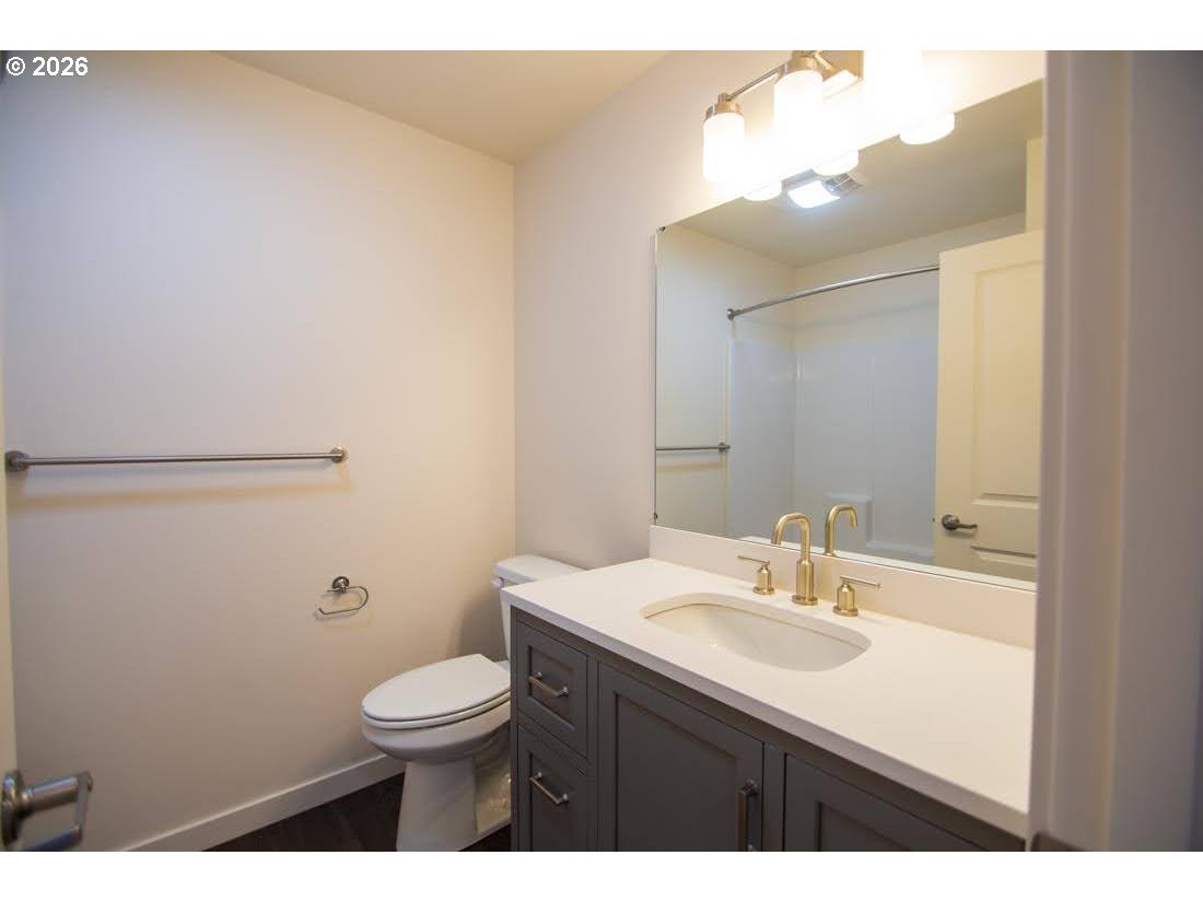1638 S Street Springfield, OR 97477 - Photo 21 of 31 a bathroom with a sink a toilet and mirror