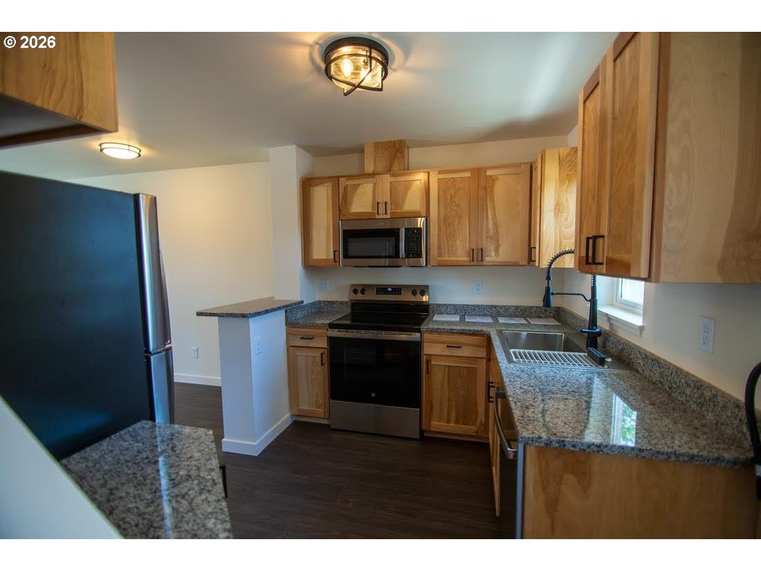 1638 S Street Springfield, OR 97477 - Photo 10 of 31 a kitchen with granite countertop a stove and a sink