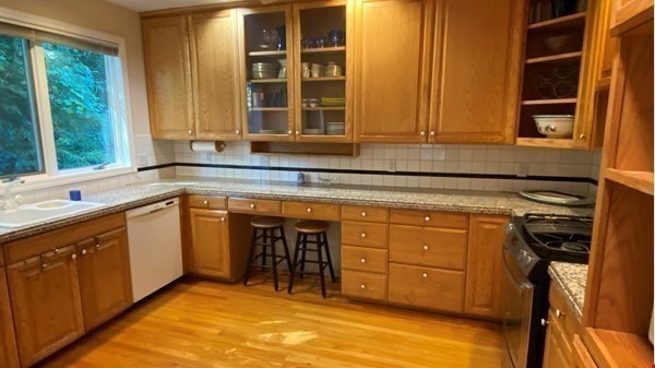 111 University Road Brookline, MA 02445 - Photo 6 of 17 a kitchen with sink cabinets and window