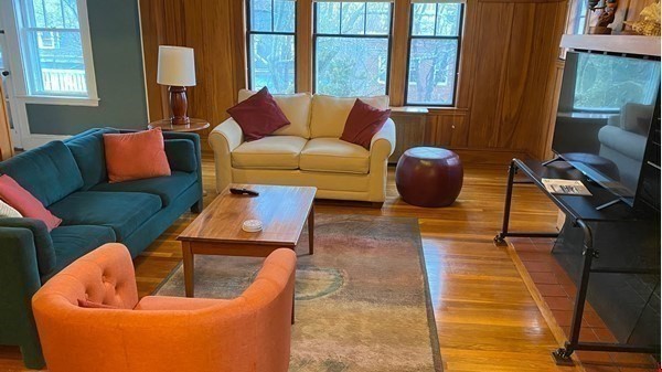111 University Road Brookline, MA 02445 - Photo 7 of 17 a living room with furniture a rug and a window