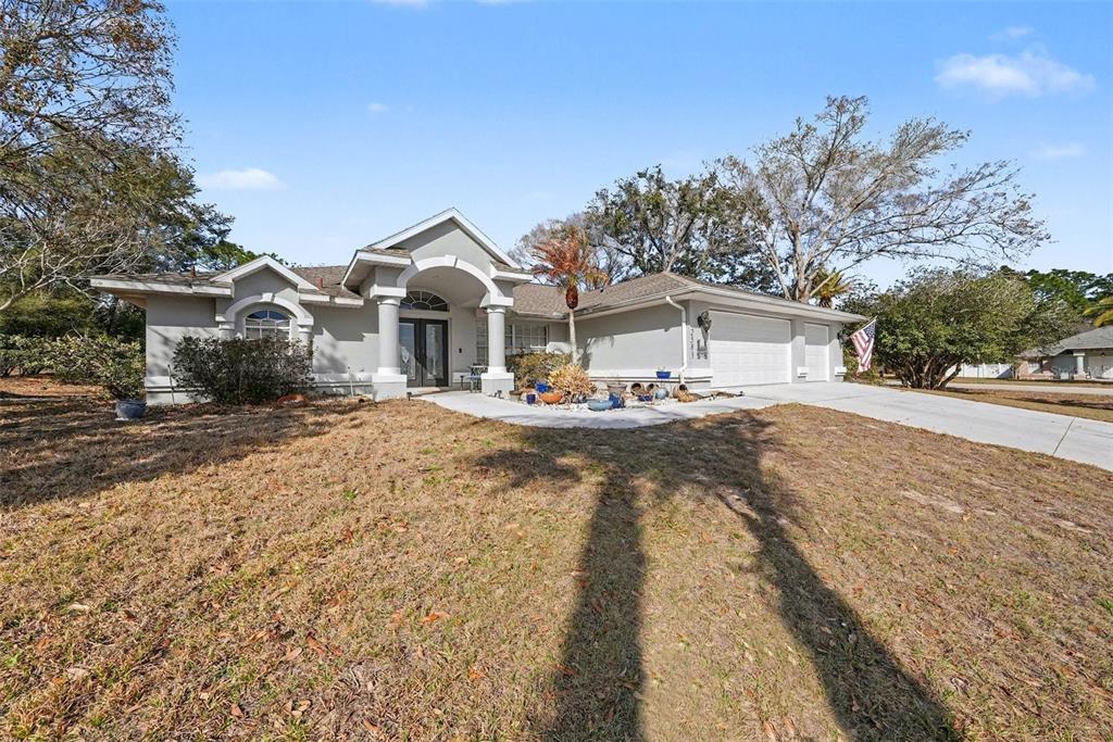 2583 Running Oak Court Spring Hill, FL 34608 - Photo 1 of 13 a front view of a house with a yard
