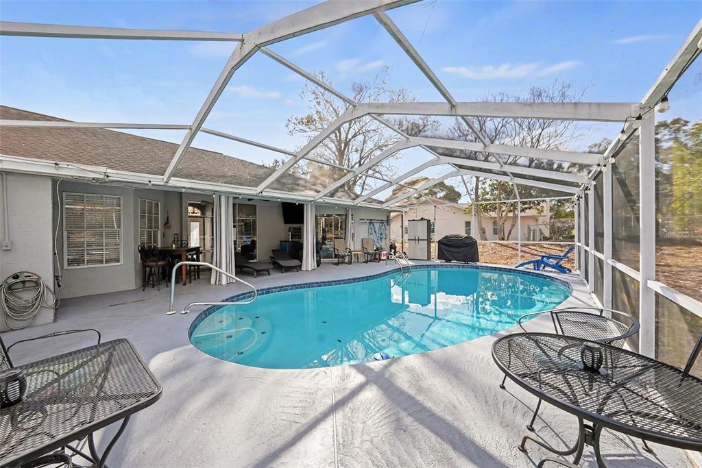 2583 Running Oak Court Spring Hill, FL 34608 - Photo 10 of 13 a view of a patio with couches chairs and potted plants
