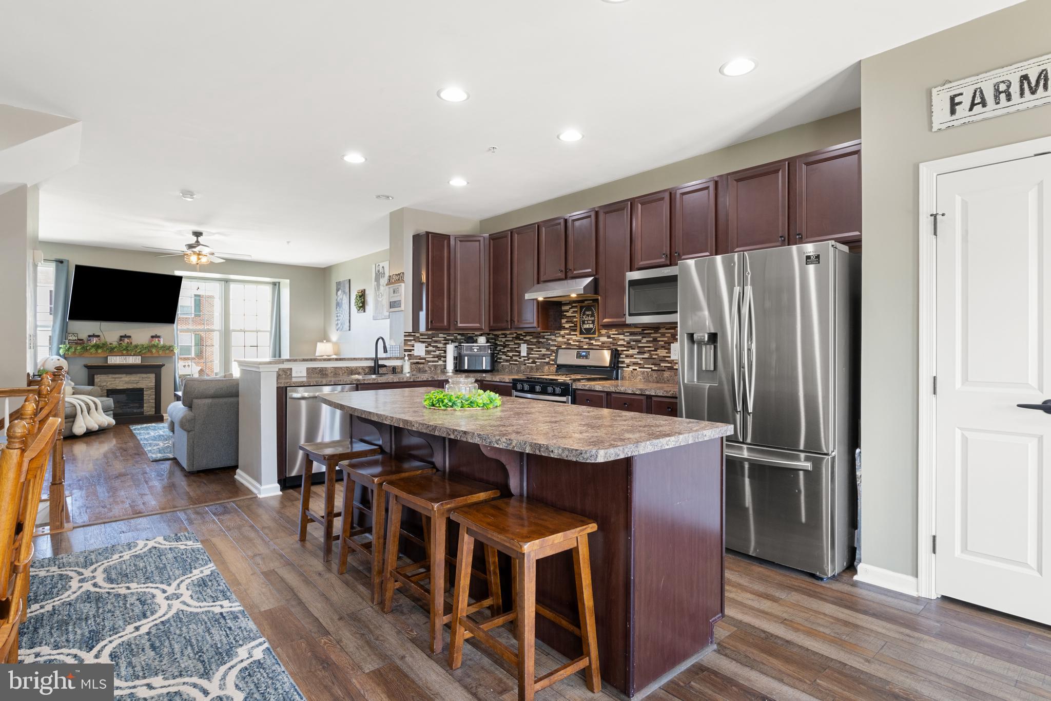 855 Blossom Drive Hanover, PA 17331 - Photo 16 of 53 a kitchen with stainless steel appliances granite countertop a refrigerator a stove a sink a dining table and chairs