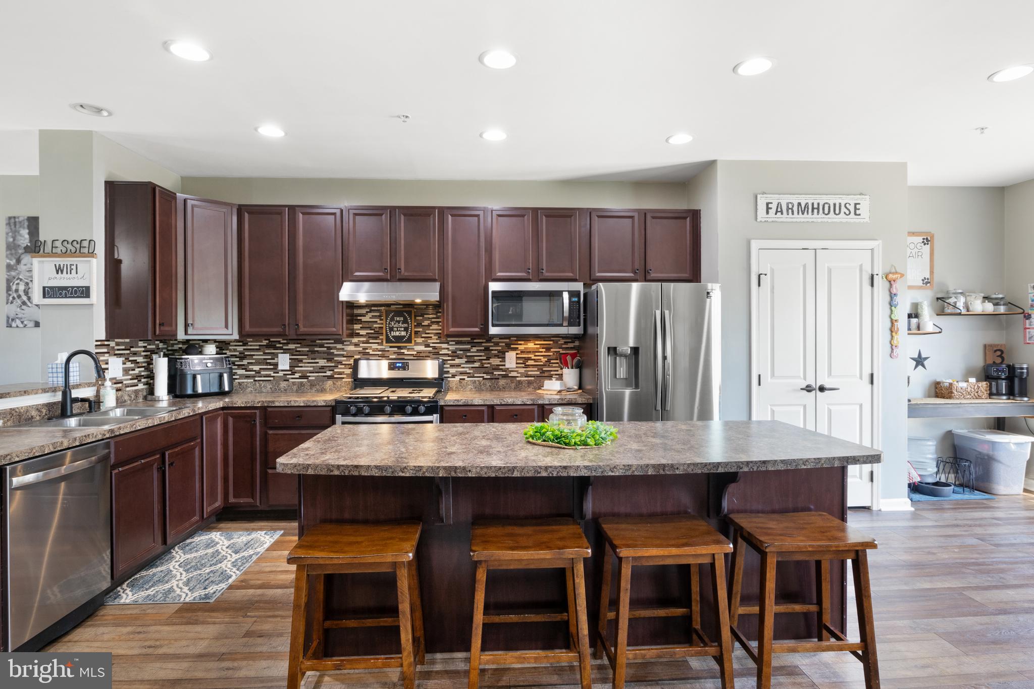 855 Blossom Drive Hanover, PA 17331 - Photo 17 of 53 a kitchen with granite countertop a table chairs stainless steel appliances and cabinets